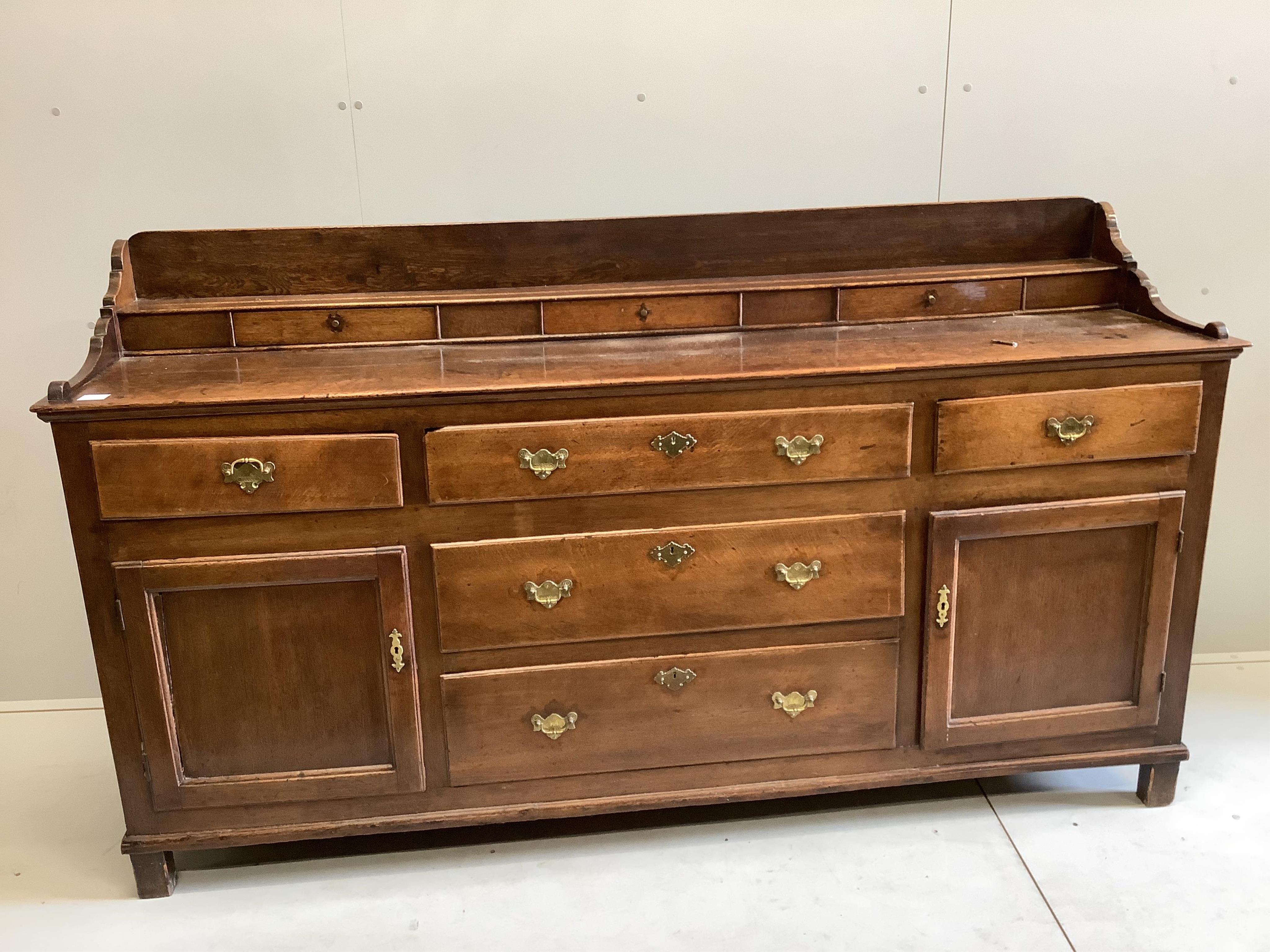 An 18th century oak low dresser, width 197cm, depth 47cm, height 110cm. Condition - fair